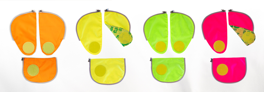 Abbildung dreiteiliger Sicherheitsset der Marke ergobag in den Neonfarben Gelb, Orange, Grün und Pink.