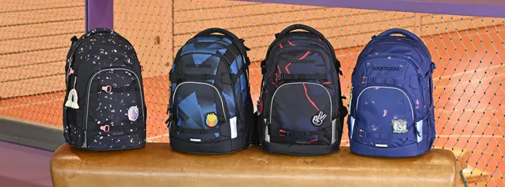 Vier Schulrucksäcke der Marke coocazoo stehen nebeneinander.