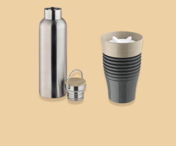 Flasche und Becher vor braunem Hintergrund.