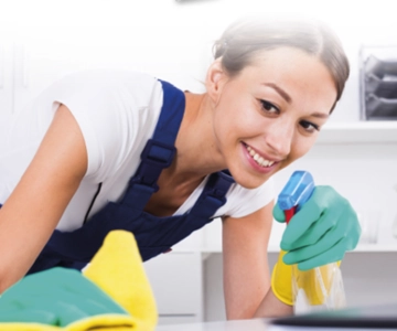 Frau reinigt eine Oberfläche.