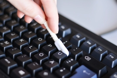 Ein Tastatur wird mit einem Reinigungstupfer gereinigt.