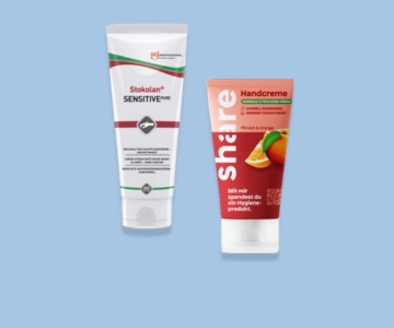 Handcreme vor blauem Hintergrund.