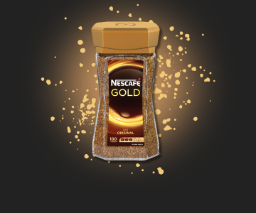 Nescafe Gold Kaffepulverdose auf Gold-gesprenkeltem Hintergrund