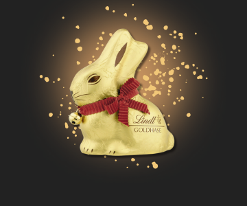 Lindt Goldhase auf Gold-gesprenkeltem Hintergrund
