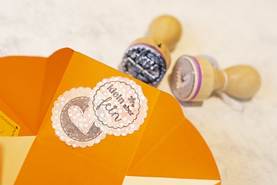 Gestempelte Verzierung auf einer Explosionsbox. Die Stempel liegen daneben.