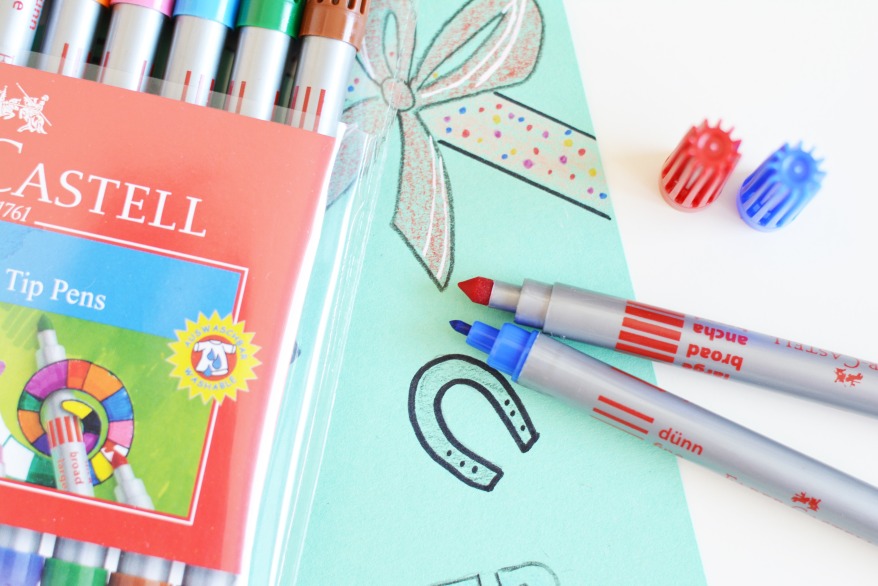 Verpackung von Faber-Castell Fasermalern, bemalte Pappe und zwei Fasermaler