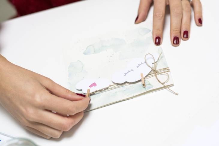 Wolkenmotive werden mit Mini-Wäscheklammern auf Karte befestigt