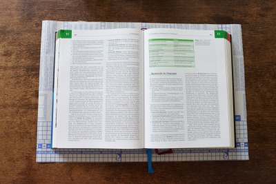 Buch liegt auf Selbstklebefolie zum Einbinden.