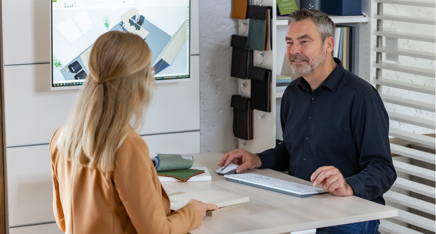Ein Mann und eine Frau, die eine Büroeinrichtung planen.