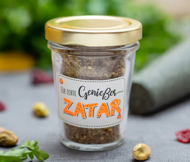 Nahaufnahme eines kleinen Marmeladenglases, gefüllt mit selbstgemachter Zatar-Mischung