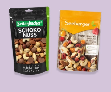 Nüsse vor lila Hintergrund.