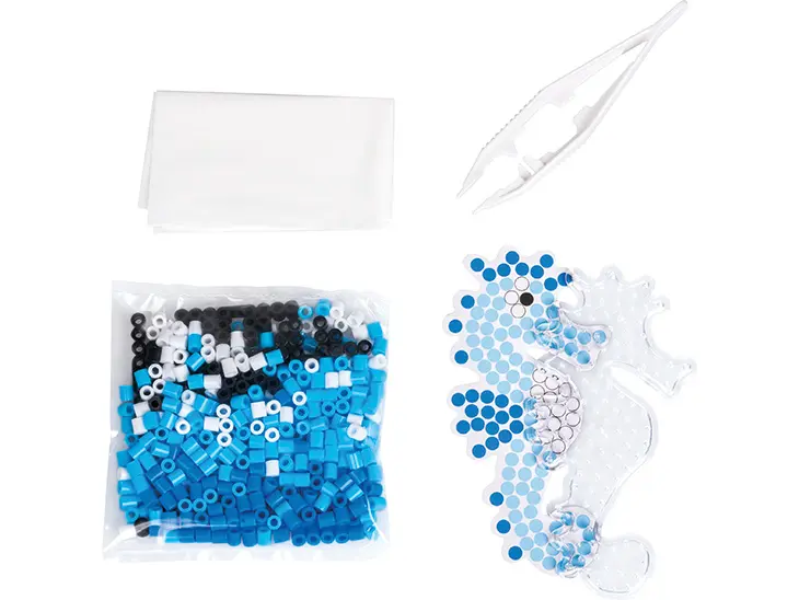 Der Inhalt des Bügelperlensets „Seepferdchen“ von KNORR prandell liegt ausgebreitet auf einem Tisch