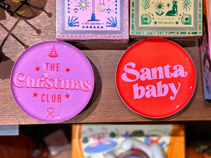 Zwei Magnete, auf denen "The Christman Club" und "Santa baby" steht.
