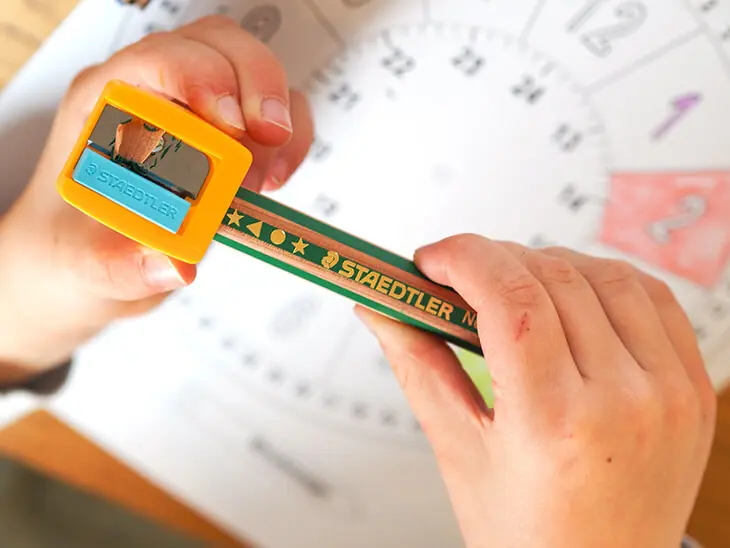 Ein Kind spitzt einen dicken Buntstift von STAEDTLER an. Foto: Johanna Rundel