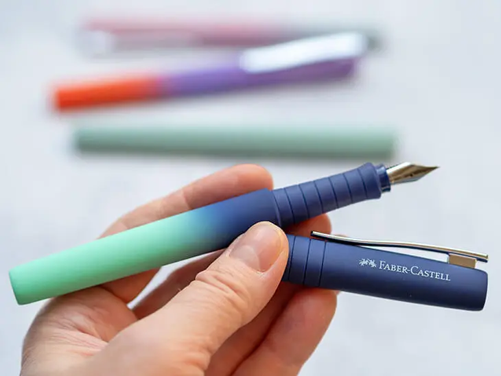 Jemand hält einen blau-türkisen Füllfederhalter von Faber-Castell in die Kamera. Foto: Johanna Rundel