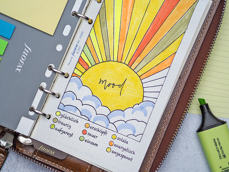 Mood Tracker mit Sonnenaufgang-Motiv in einem Organizer von Filofax. Foto: Johanna Rundel
