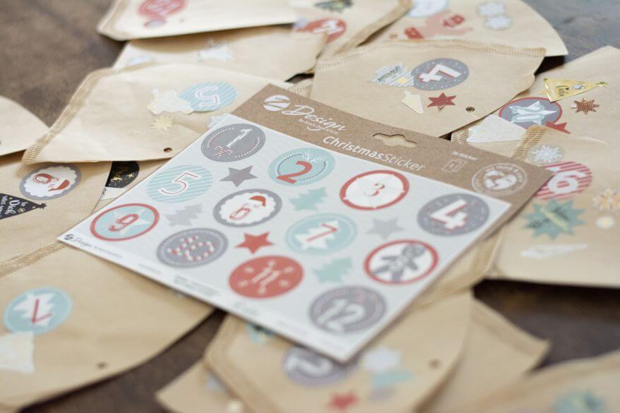Auf verschiedenen beklebten Kaffeefiltern liegt eine Packung Christmanstickern von Avery Zweckform.