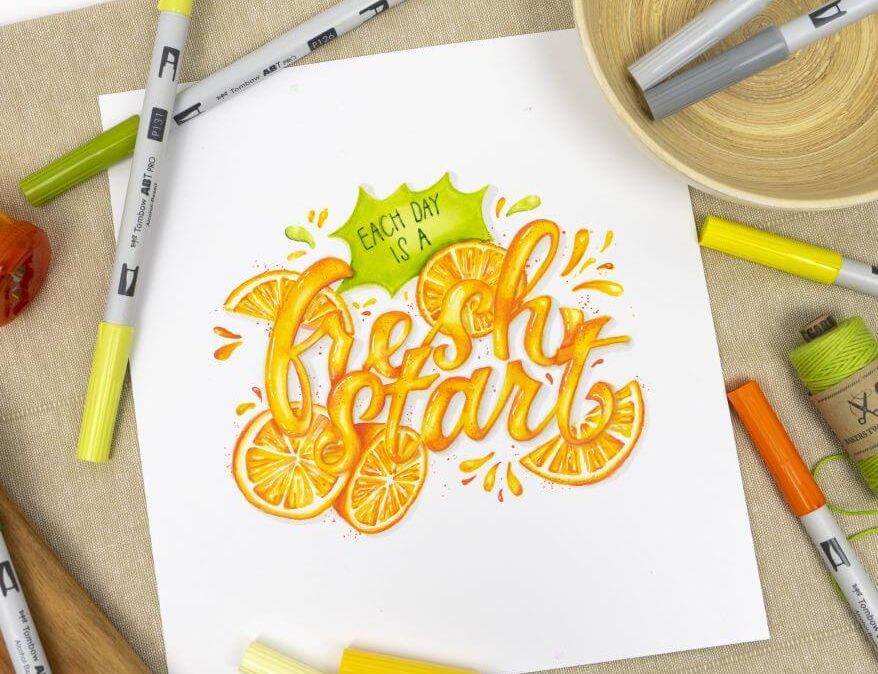 Handlettering von Kathrin-Nina Vinko mit den Alkoholmarkern ABT PRO von Tombow: "Each day is a fresh start". Der Lettering-Schriftzug wurde mit illustrierten Orangen verziert.