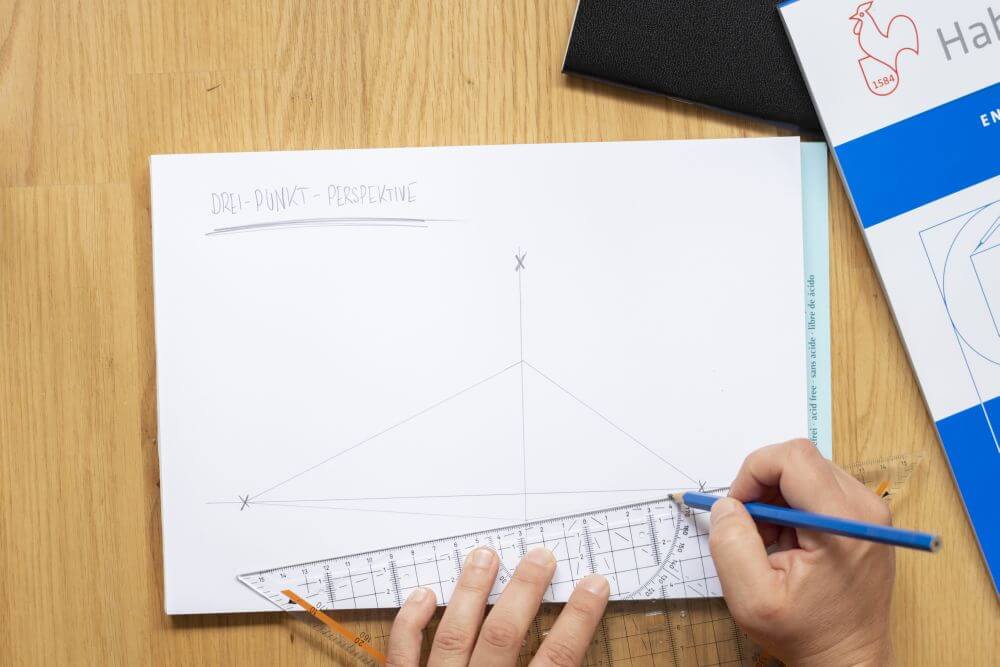 3-Punkt-Perspektive Schritt 4: Auf der vertikalen Linie die Höhe des Körpers bestimmen und von dort Fluchtlinien zu den beiden Fluchtpunkten der Horizontlinie ziehen.