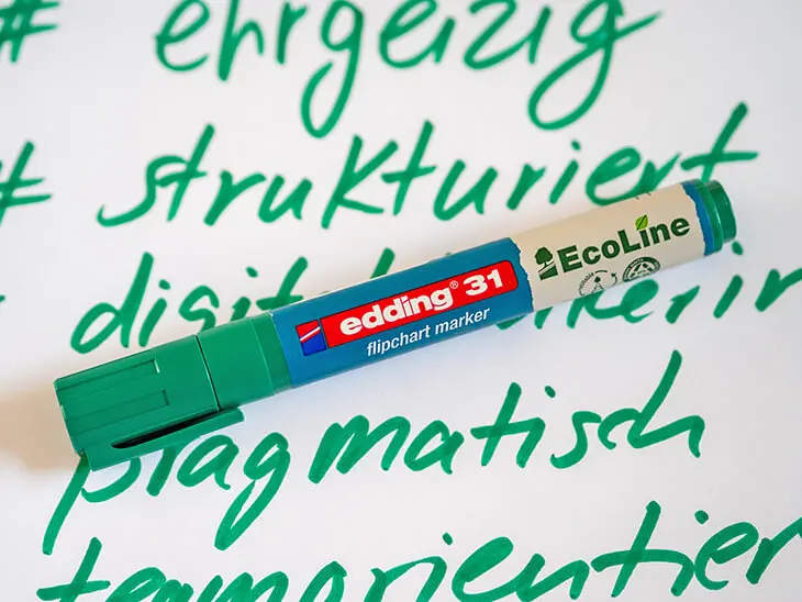 Grüner EcoLine Flipchart-Marker von edding liegt auf Flipchart. Foto: Johanna Rundel