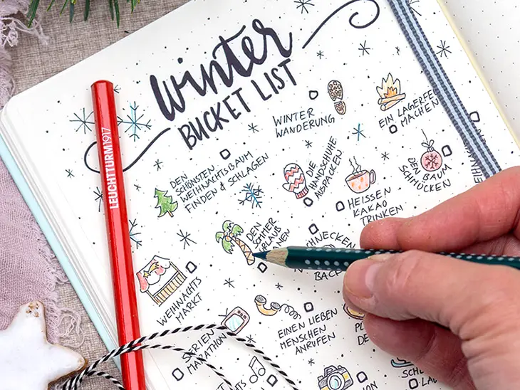 Jemand zeichnet aus vielen verschiedenen, winterlichen Doodles eine „Winter-Bucket-Liste“ in ein Bullet Journal von LEUCHTTURM1917. Foto: Johanna Rundel